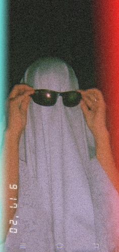 a person with sunglasses covering their face