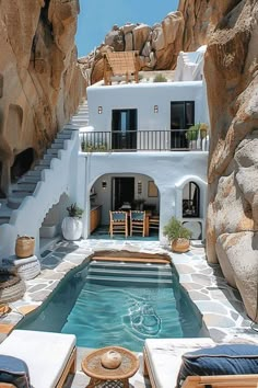 an outdoor swimming pool in front of a house