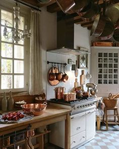 a kitchen with pots and pans hanging from the ceiling