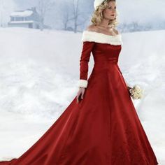 a woman in a long red dress is standing in the snow wearing a white hat