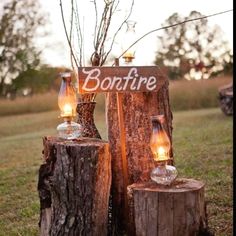 an image of a wooden post with candles on it and the words bonfire written in white