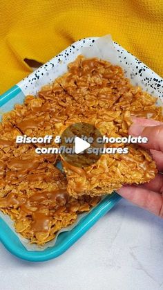 someone is holding up some kind of granola in front of a plate with chocolate