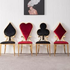 three chairs with hearts and spades on them in front of a wall mounted painting