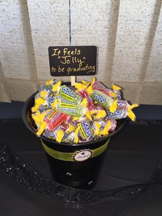 a bucket filled with candy sitting on top of a table