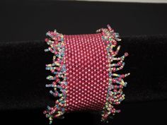 You will love this fun, fringed bracelet for dress or casual. Bright colors of pink with yellow and aqua accents in fringe.  Present size can be adjusted prior to shipping.  Custom made for size and color for additional $25.  Snap closure hidden by beads and easy to put on and take off but holds securely Fringe Bracelet, Peacock Earrings, Beaded Fringe, Green Earrings, Hand Beading, Beaded Chain, Beading Patterns, Handmade Items, Beaded Bracelets