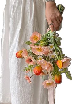 a person holding a bouquet of flowers in their hand