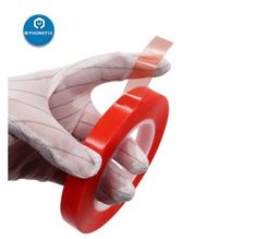 a pair of gloves holding a red tape