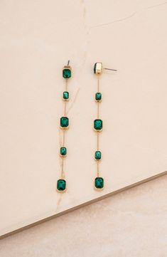 Dainty baguette-cut crystal stations bring elegant sparkle to linear drop earrings crafted from lustrous 18-karat-gold plate. 4" drop; 1/4" width Post back Glass/18k-gold plate Imported Cute Gold Dangle Earrings, Good Drop Earrings, Forest Green Earrings, Emerald And Gold Earrings, Green Wedding Earrings, Emerald Green Shoes, Earring Dangling, Green And Gold Earrings, Emerald Drop Earrings