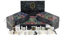 an assortment of perfumes in black boxes with gold designs on the top and bottom