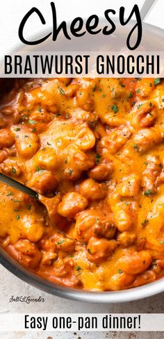 a white bowl filled with cheese and meat covered in gravy on top of a table