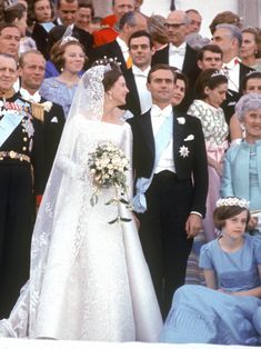 the bride and groom are surrounded by their families