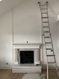 a living room with a fire place and ladder