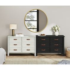 a white dresser sitting next to a mirror on top of a wall