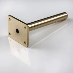 a brass door handle on a white surface