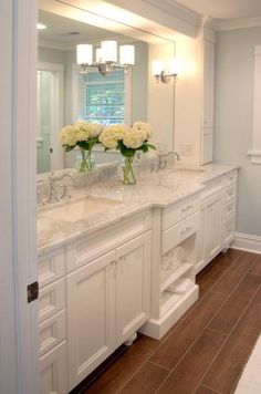 a large bathroom with two sinks and mirrors