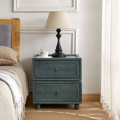 This nightstand brings a touch of farmhouse charm and transitional style to your bedroom. Crafted from kiln-dried solid paulownia wood, it features a stacked, rectangular shape with a finished back, ensuring it looks great from every angle. The two drawers glide smoothly on roller glides, offering easy access to your bedside essentials. Antique bronze ring handles add a vintage touch, complementing the rustic appeal of the paneled drawer fronts. With its versatile design, this nightstand can als Antique Bedside Tables, Transitional Nightstand, Nightstand Makeover, Bedside Essentials, Bronze Handles, Rustic Nightstand, Paulownia Wood, Primary Bedroom, 2 Drawer Nightstand