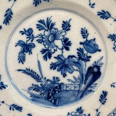 a blue and white plate with flowers on it