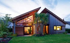 a house with a palm tree in front of it and grass on the ground next to it