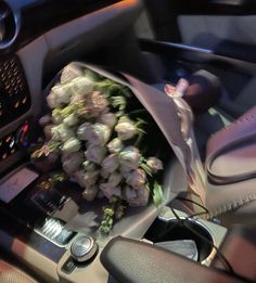 a bouquet of flowers is sitting in the driver's seat of a car