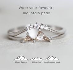 an advertisement for a mountain peak engagement ring with three pear shaped diamonds on each band