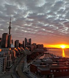 the sun is setting over a large city