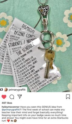 a bunch of keys that are on top of a keychain with some paper attached to it