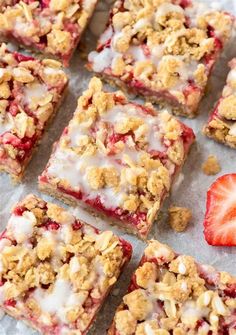 strawberry crumbler bars with white icing and strawberries on the top, ready to be eaten