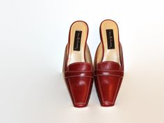 This listing is for a pair of vintage David Aaron mules, size 6 in excellent condition. These shoes are designed with tapered square toes, and have a band across the top. The low wood heels measure 2 inches. Guaranteed to be in excellent condition. Wood Heels, Tapered Square, Clogs And Mules, Maroon Leather, Wood Heel, Loafer Mules, Red Maroon, Leather Mules, Clogs Shoes