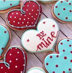 decorated heart shaped cookies with the words be mine written in red, white and blue