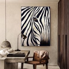 a zebra print hangs on the wall above a desk