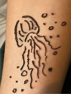 a woman's arm with a tattoo on it that looks like a jellyfish