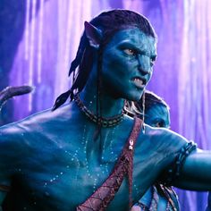 a man dressed as avatar from avatar with blue paint on his face and chest, standing in front of purple background