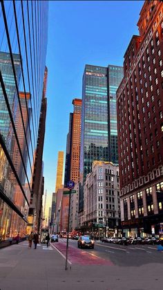 an empty city street with tall buildings in the background