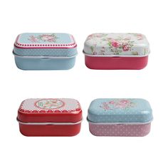 four different colored tins with flowers and polka dots on the top one is pink, green, blue, and white