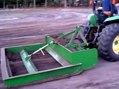 a man driving a tractor with a plow attached to it's front end