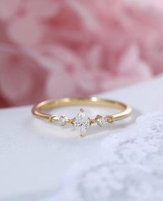 a diamond ring sitting on top of a white table