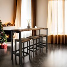 a dining table with three stools next to a christmas tree