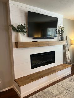 a flat screen tv mounted above a fireplace