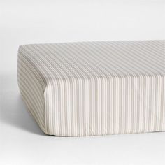 a white and beige striped bed spread