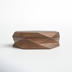 a wooden box sitting on top of a white table