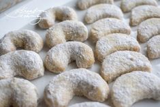 powdered sugar donuts on a baking sheet ready to be baked