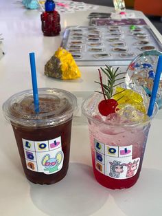 two drinks sitting on top of a table next to each other