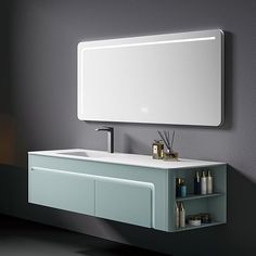 a bathroom sink with a mirror above it next to a wall mounted faucet