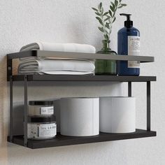 a shelf with toiletries and other items on it next to a wall mounted towel dispenser