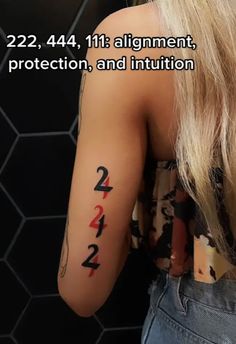 the back of a woman's arm with numbers tattooed on it and an arrow