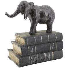 a statue of an elephant standing on three books