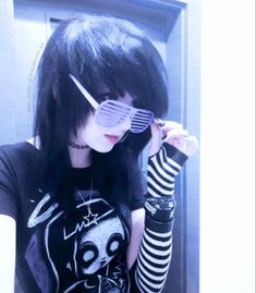 a girl with long black hair and sunglasses