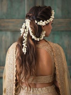 a woman with long hair and flowers in her hair