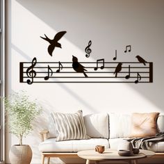 a living room with a white couch and musical notes on the wall, birds flying around