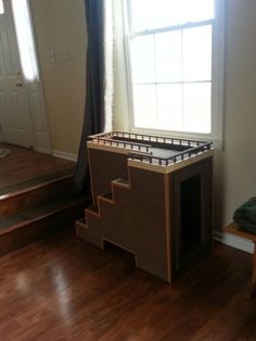 an empty room with a bed frame and stairs in the corner, next to a window